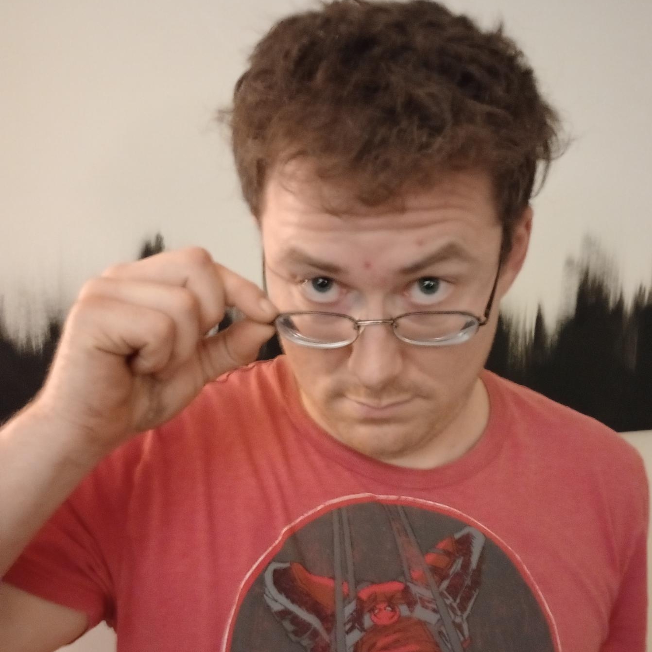 Kevin looking over the top of their glasses.